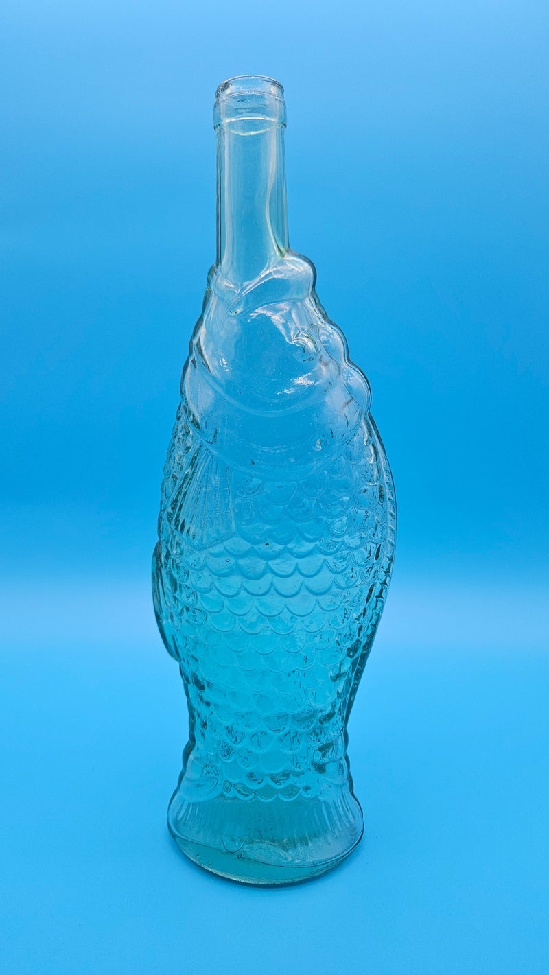 Decorative vintage glass bottle in fish shape