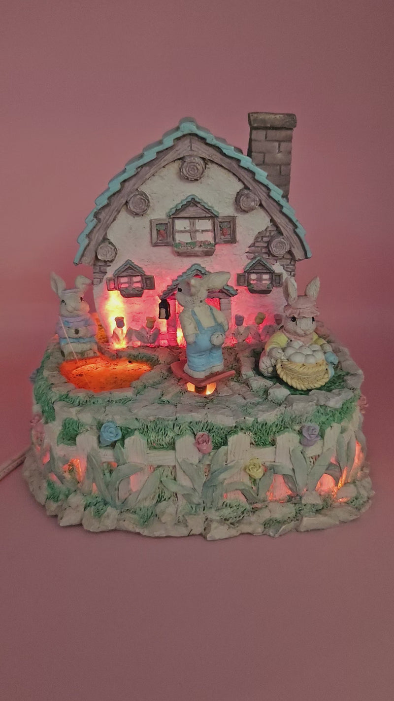 Vintage ABC Easter bunny cottage figurine with lighted house, animated bunnies, and music box that plays "Easter Parade" – ceramic 6-inch display