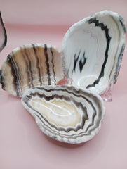 Polished natural onyx shell bowls with layered cream, gray, and brown tones