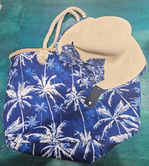 Close-up of teal beach bag with rope handles and seashell, starfish, and palm print, stacked over navy palm print bag.