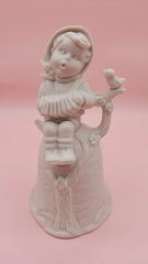 Unpainted vintage ceramic bisque bell featuring a boy with accordion sitting on a tree with bird detail, Provincial Mold #P-447, 4.8x2.8 inches.