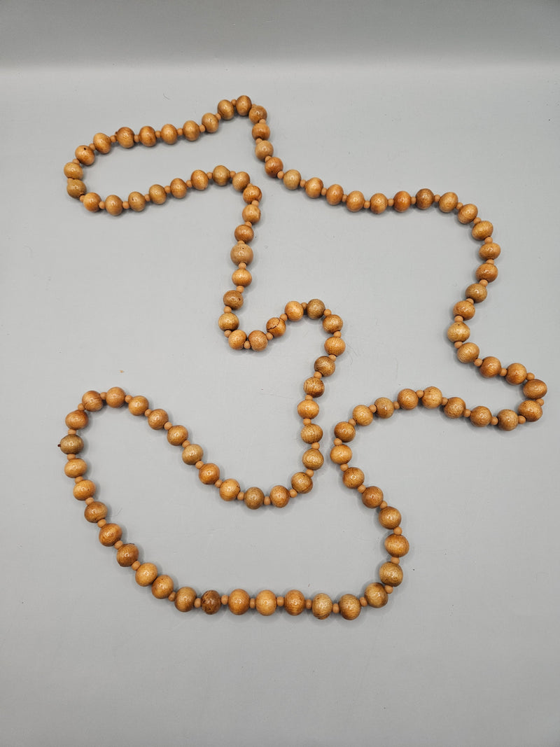 A vintage 24" wood bead necklace featuring natural wooden beads in a boho style