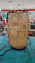 handwoven rattan backpack basket with natural braided straps and open lattice pattern 
