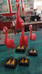 Hand-painted pink flamingo bird sculptures with metal legs on black bases, coastal-themed decorative figurines