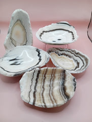 Polished natural onyx shell bowls with layered cream, gray, and brown tones