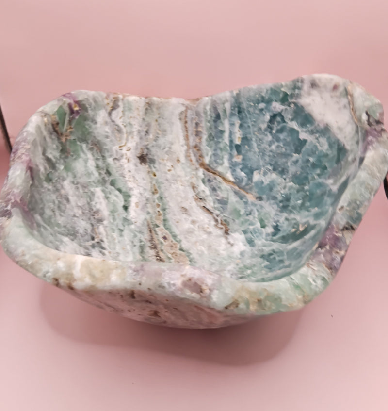 and-carved fluorite bowl featuring layers of green, purple, and aqua crystal