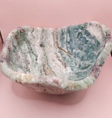 and-carved fluorite bowl featuring layers of green, purple, and aqua crystal