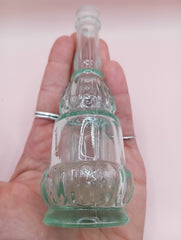 Vintage miniature apothecary-style green glass bottle with figural design