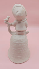 Unpainted vintage ceramic bisque bell featuring a boy with accordion sitting on a tree with bird detail, Provincial Mold #P-447, 4.8x2.8 inches.