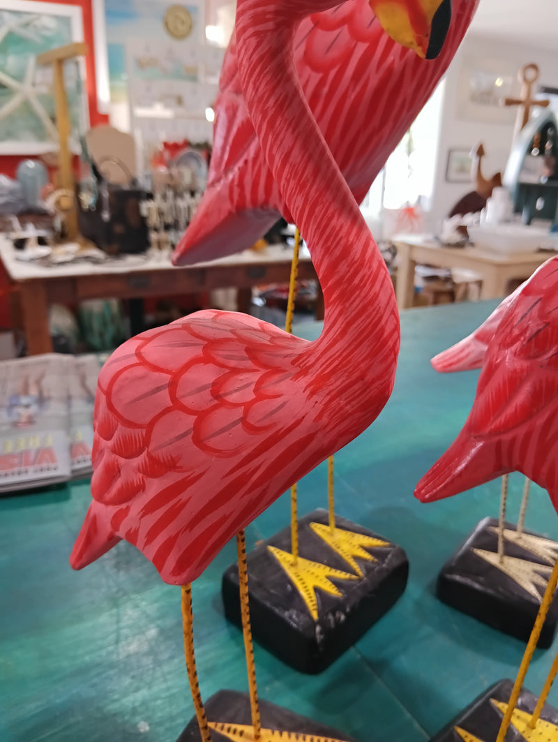 Hand-painted pink flamingo bird sculptures with metal legs on black bases, coastal-themed decorative figurines
