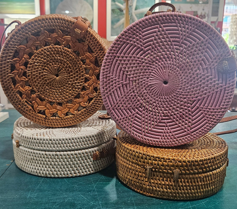 Round rattan crossbody bags in 4 styles—natural, pink, whitewash, and floral weave—with fabric-lined interior
