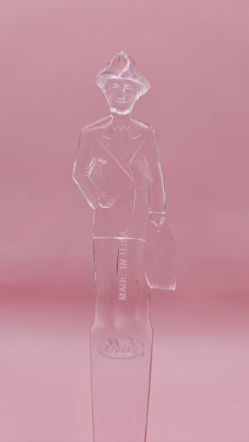 Vintage clear plastic Fuller Brush Man letter opener, shaped like a businessman holding a briefcase, measuring 7.25 inches long.