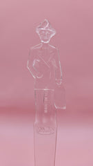 Vintage clear plastic Fuller Brush Man letter opener, shaped like a businessman holding a briefcase, measuring 7.25 inches long.