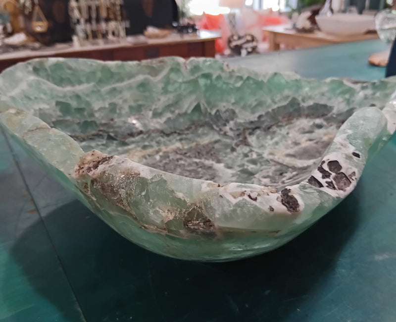 Carved green and purple fluorite crystal bowl with raw edge