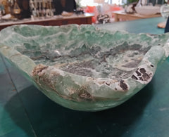 Carved green and purple fluorite crystal bowl with raw edge