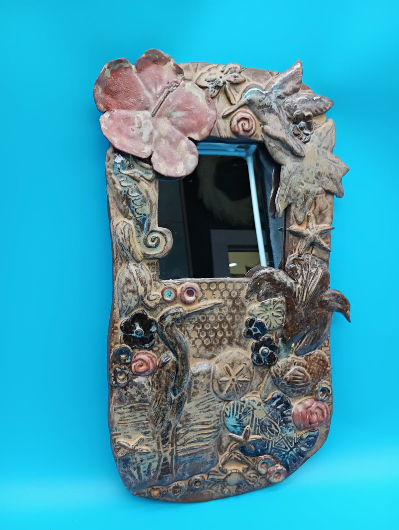 Handmade ceramic coastal mirror with hibiscus, heron, shells, and sand dollar – 13.5" x 8"