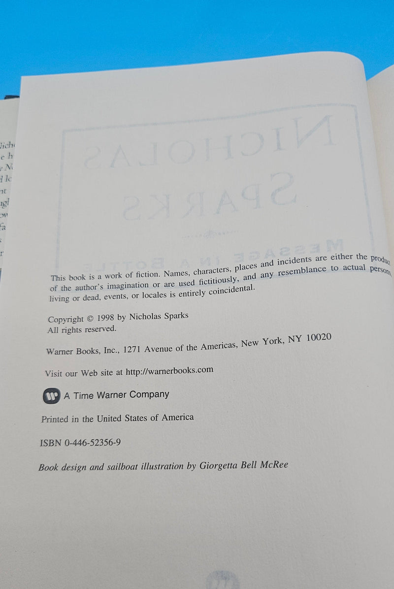 1998 hardcover edition of Message in a Bottle by Nicholas Sparks with dust jacket showing sailboat on ocean waves.