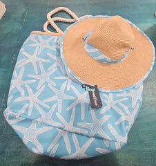 Close-up of teal beach bag with rope handles and seashell, starfish, and palm print, stacked over navy palm print bag.