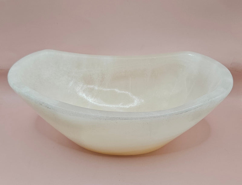 Polished white onyx bowl with smooth curves and a subtle translucent glow, measuring 9.75 inches.