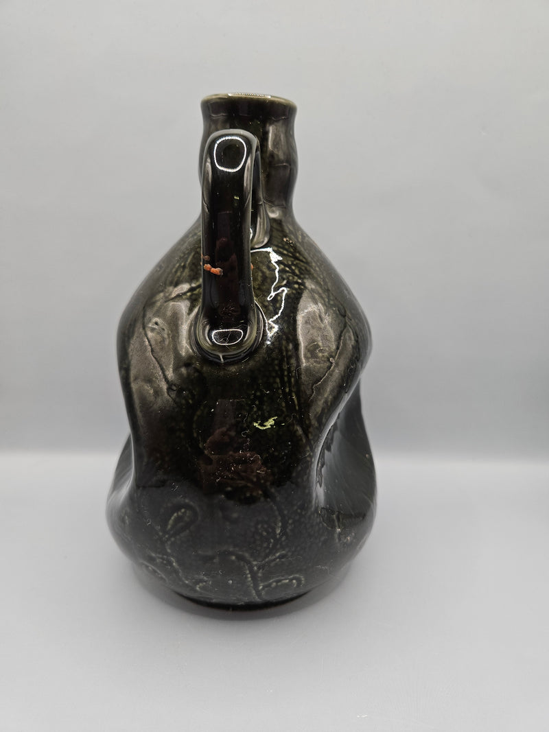  vintage Dewar's Whiskey ceramic decanter, measuring 7.5"x5.5", without a stopper. Perfect for display or bar decor.