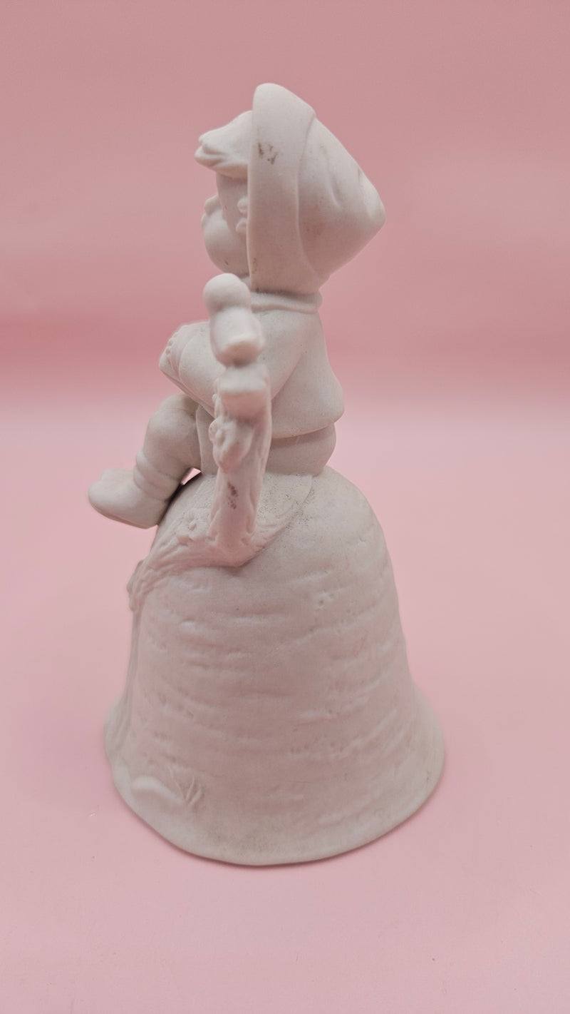 Unpainted vintage ceramic bisque bell featuring a boy with accordion sitting on a tree with bird detail, Provincial Mold #P-447, 4.8x2.8 inches.
