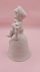 Unpainted vintage ceramic bisque bell featuring a boy with accordion sitting on a tree with bird detail, Provincial Mold #P-447, 4.8x2.8 inches.
