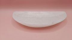 White onyx crescent-shaped shallow bowl with a polished finish.