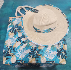 Close-up of teal beach bag with rope handles and seashell, starfish, and palm print, stacked over navy palm print bag.