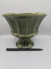 A vintage olive green ribbed pedestal planter/vase by FTD and Haeger, perfect for home decor or displaying plants, with a mid-century aesthetic.