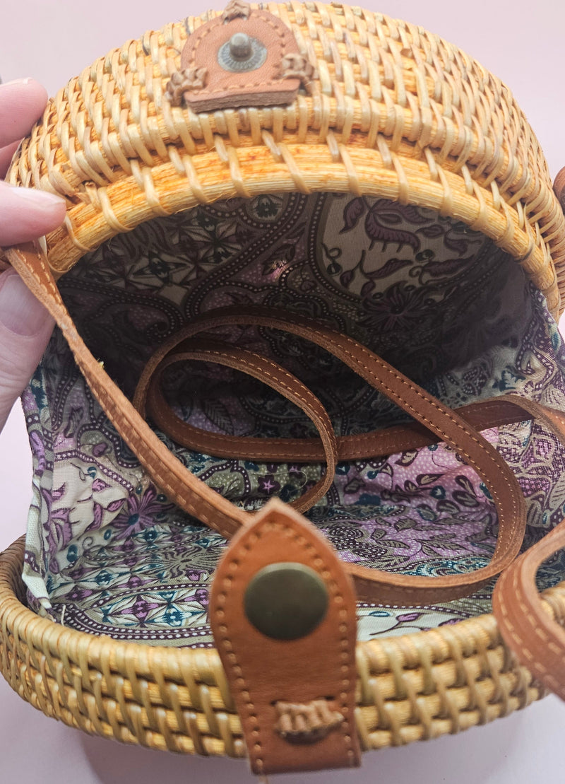 Round rattan crossbody bags in 4 styles—natural, pink, whitewash, and floral weave—with fabric-lined interior
