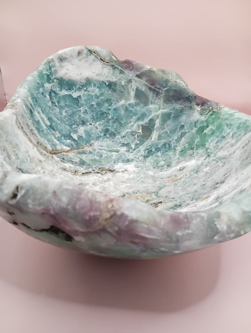 and-carved fluorite bowl featuring layers of green, purple, and aqua crystal