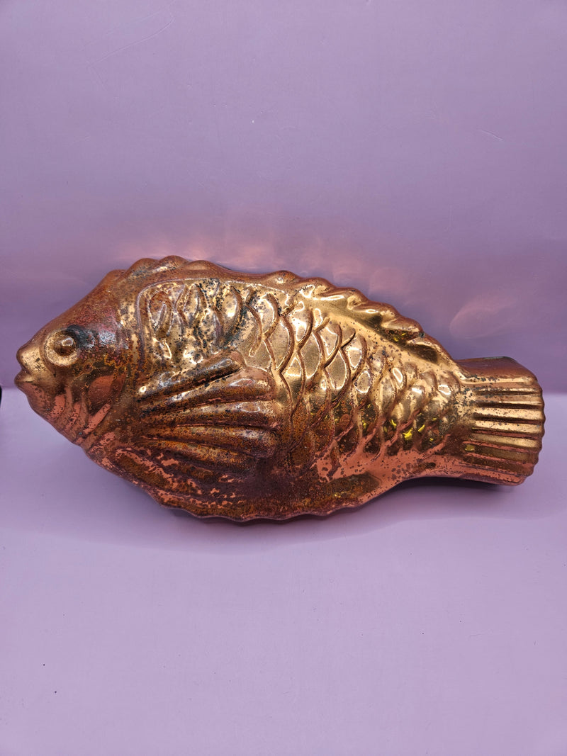 Vintage copper fish mold showcasing polished finish and intricate details