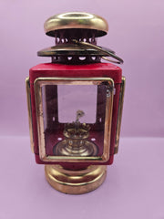 Vintage red and gold nautical oil lamp lantern with glass panels and vent, 7.5 inches by 4 inches, perfect for coastal decor