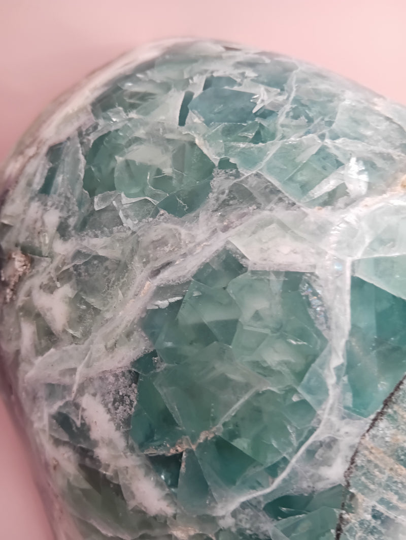 and-carved fluorite bowl featuring layers of green, purple, and aqua crystal