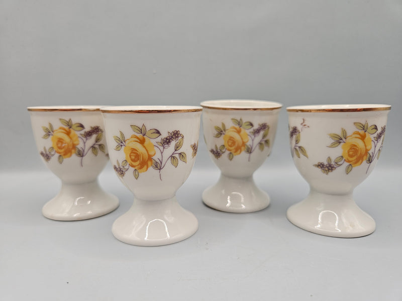 set of 4 vintage porcelain egg cups with a yellow rose design and silver edge, measuring 2.5"x2", perfect for adding elegance to your table setting.