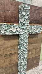 Rustic wooden cross decorated with green-blue limpet shells for coastal wall décor 26x19.75