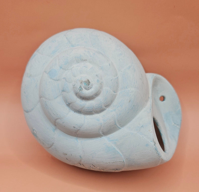 Two vintage ceramic shell wall hangings with pre-drilled holes, shown on a teal background, perfect for coastal décor or DIY projects.