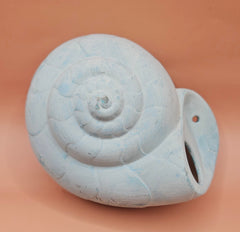 Two vintage ceramic shell wall hangings with pre-drilled holes, shown on a teal background, perfect for coastal décor or DIY projects.