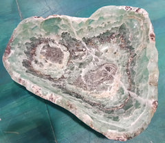 Carved green and purple fluorite crystal bowl with raw edge