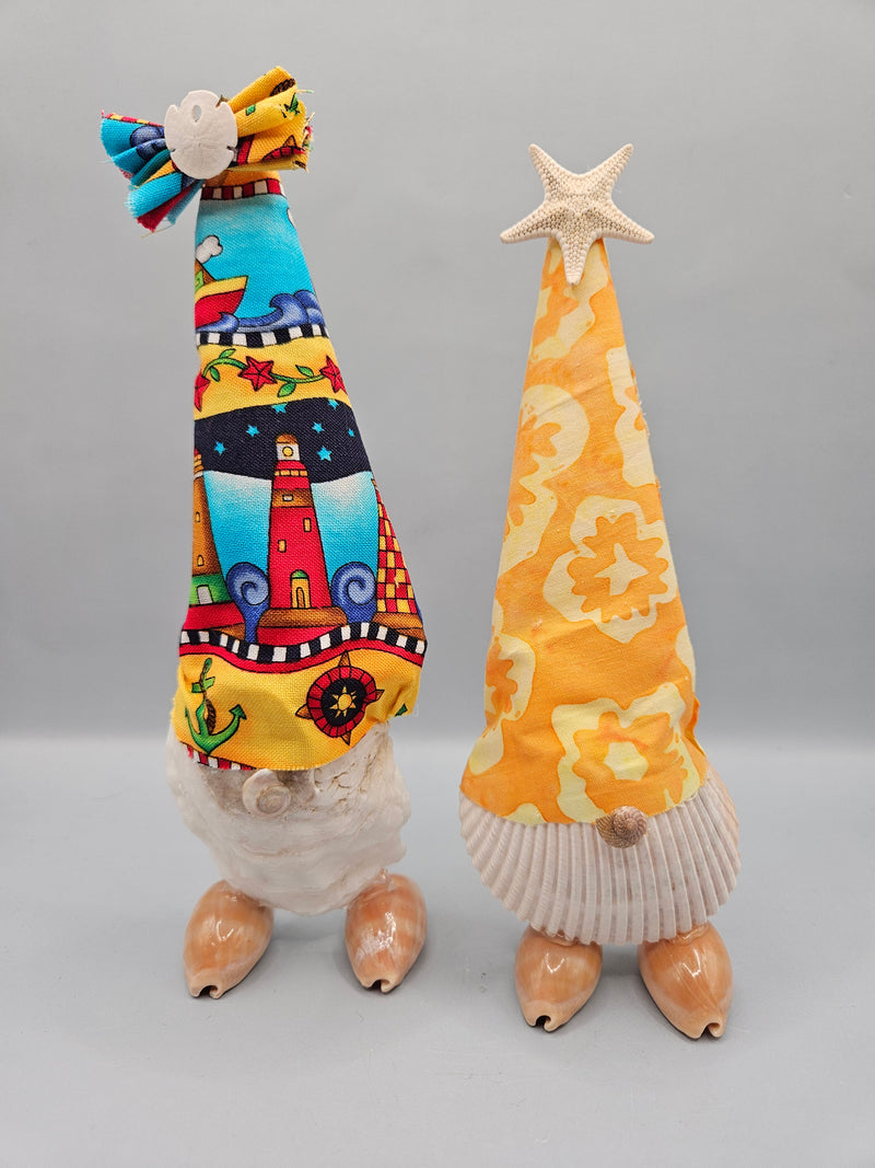 handcrafted seashell gnome with a colorful fabric hat and real seashells, perfect for coastal or beach-themed decor.