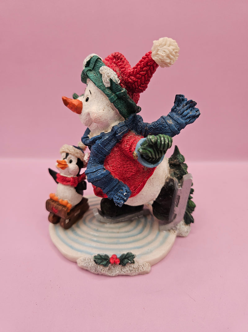 Vintage ice skating snowman and penguin figurine, 4.5 inches tall by 4 inches wide, perfect for holiday decor and winter displays