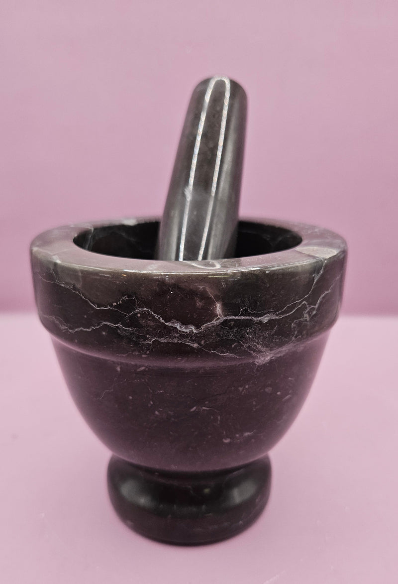 Three stone mortar and pestle sets in beige, brown, and black, featuring a durable design for grinding spices and herbs.