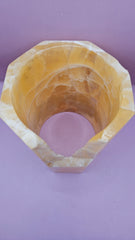 Honeycomb calcite candle cover with translucent golden tones and a hexagonal shape, measuring 6.75x5.5 inches.