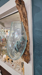 Wall-hanging teak wood and molten glass terrarium. Handcrafted design with molten glass fused to a natural teak wood base, creating a unique and rustic aesthetic. Perfect for displaying plants, flowers, or decorative items