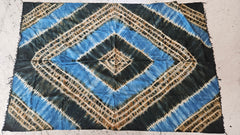  A vintage African handwoven tapestry with indigo blue and earthy brown tie-dye geometric patterns, measuring 65