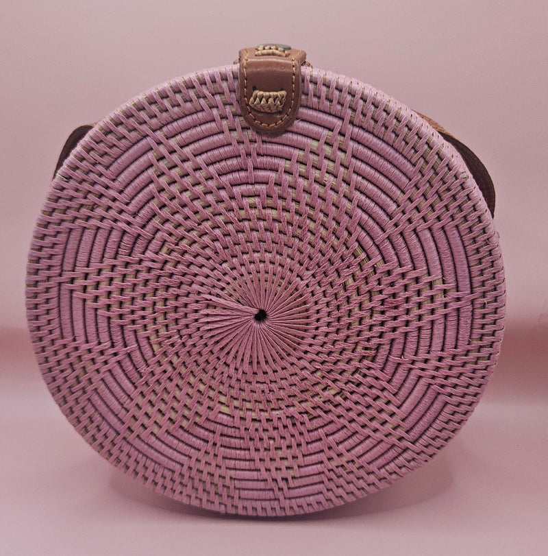 Round rattan crossbody bags in 4 styles—natural, pink, whitewash, and floral weave—with fabric-lined interior