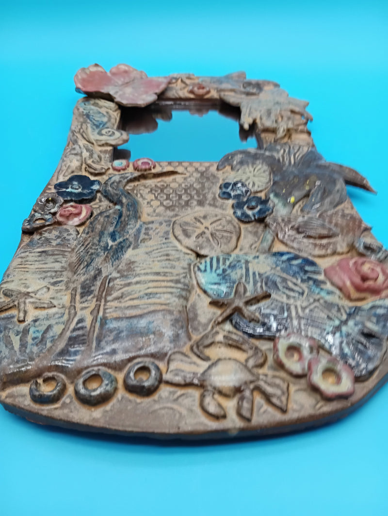 Handmade ceramic coastal mirror with hibiscus, heron, shells, and sand dollar – 13.5" x 8"