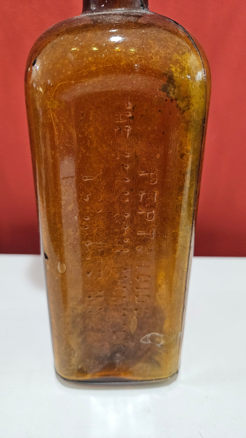 Antique amber Pepto-Mangan bottle with abalone shell and sea fan coral topper