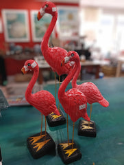 Hand-painted pink flamingo bird sculptures with metal legs on black bases, coastal-themed decorative figurines
