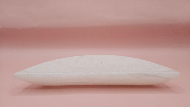 White onyx crescent-shaped shallow bowl with a polished finish.